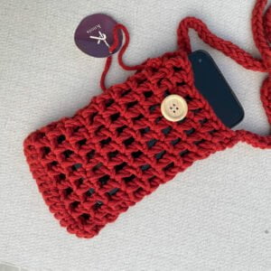 A hand-made, crocheted mobile pouch in red color