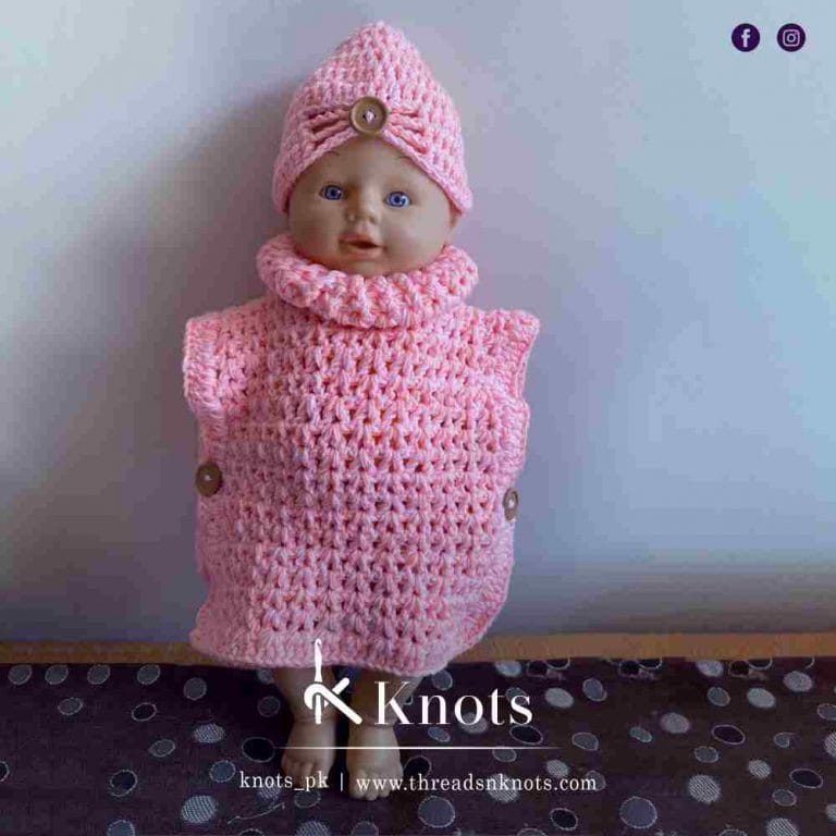 A baby dummy wearing Hand-knitted crochet turtle neck Sweater and cap